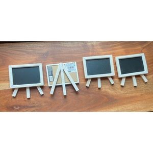 Four small white chalkboard Easels.